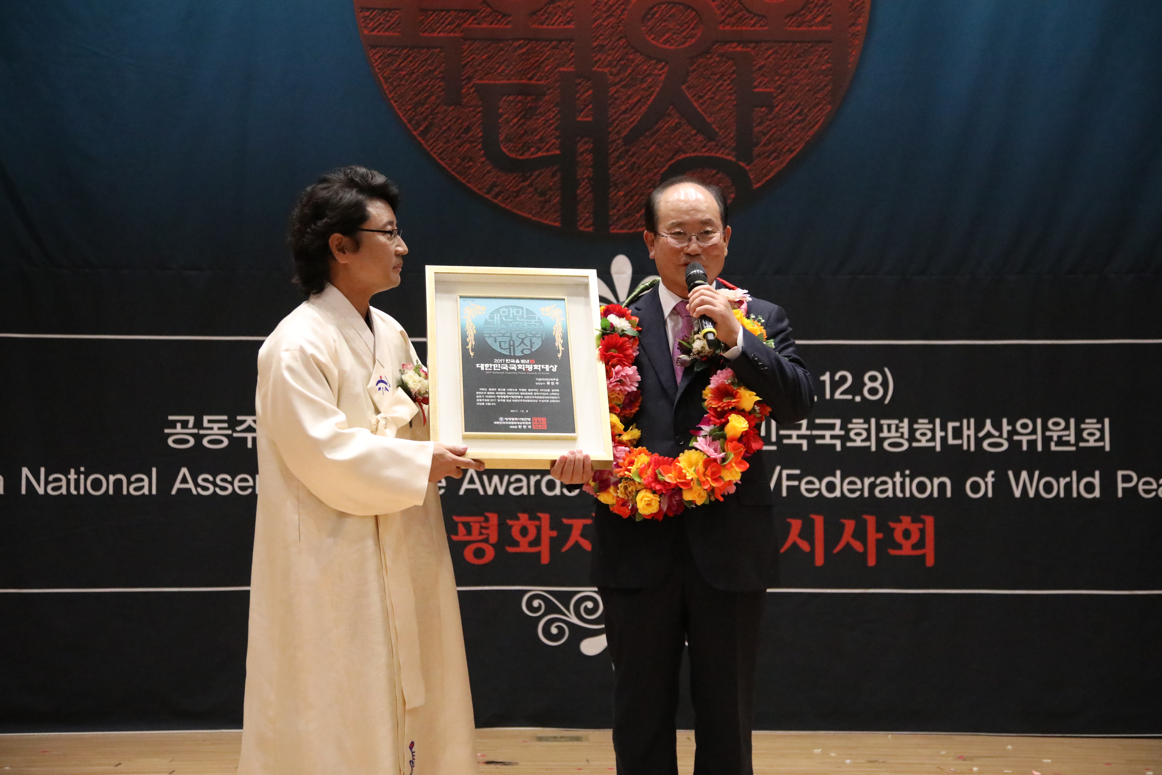 한한국(세계평화사랑연맹 이사장)대회장이 류한우(지방자치단체부문)단양군수에게 시상을 하고 기념촬영을 하고 있다(사진=세계평화사랑연맹 제공)